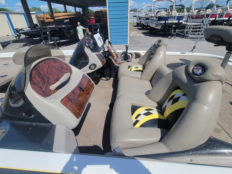 Slide: The Image of 2003 Ranger 521VX NASCAR boat interior with beige seats and wood paneling. - 9