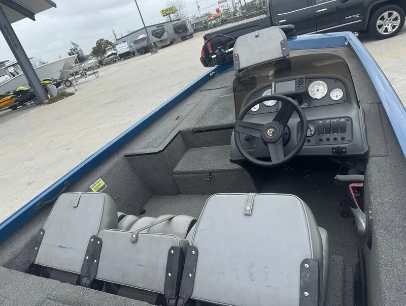 Slide: The Image of Interior of a 2007 Triton TS 17 boat with steering wheel and seating. - 10