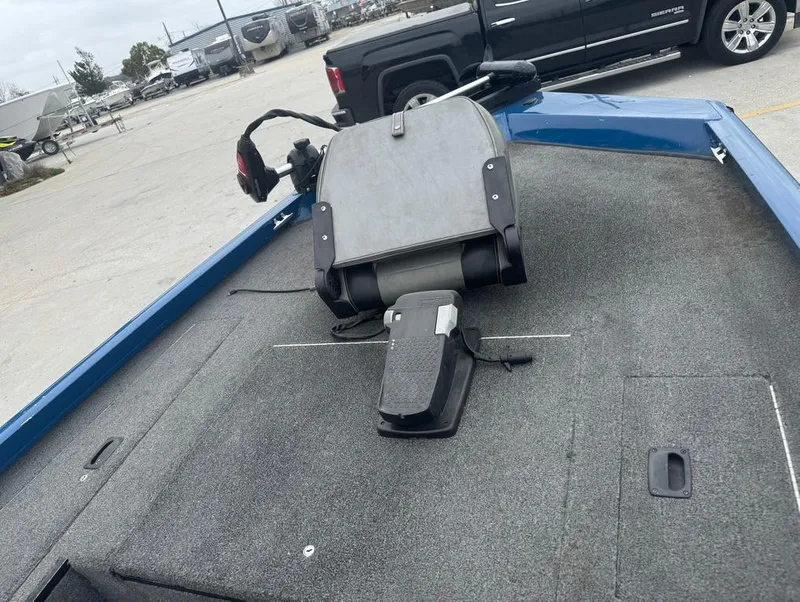 Slide: The Image of 2007 Triton TS 17 boat interior with seat and control panel, parked in a lot. - 12