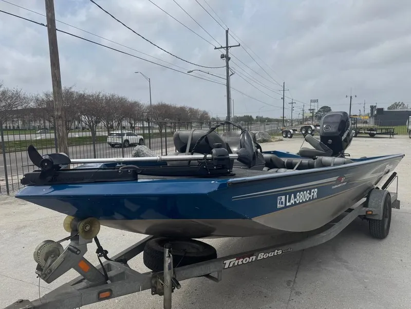 Slide: The Image of 2007 Triton TS 17 boat on trailer, parked outdoors under cloudy sky. - 3