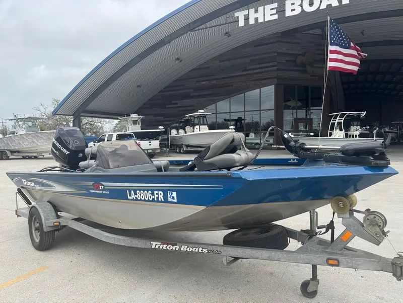 Slide: The Image of 2007 Triton TS 17 boat on trailer, parked outside dealership with American flag. - 5