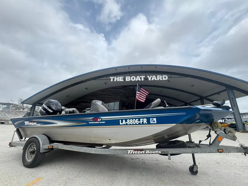 Slide: The Image of 2007 Triton TS 17 boat on trailer at The Boat Yard, American flag displayed. - 6