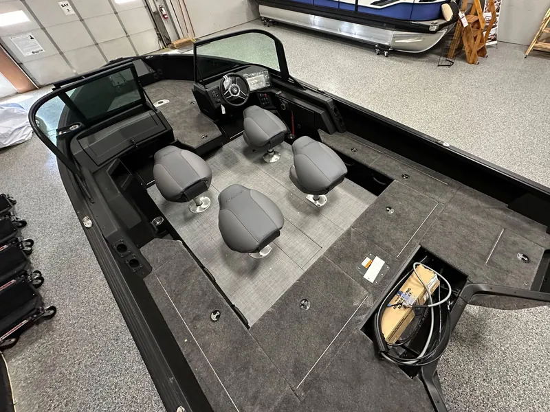 Slide: The Image of 2025 Alumacraft Competitor 185X Sport interior with four seats, spacious layout, and modern design. - 10