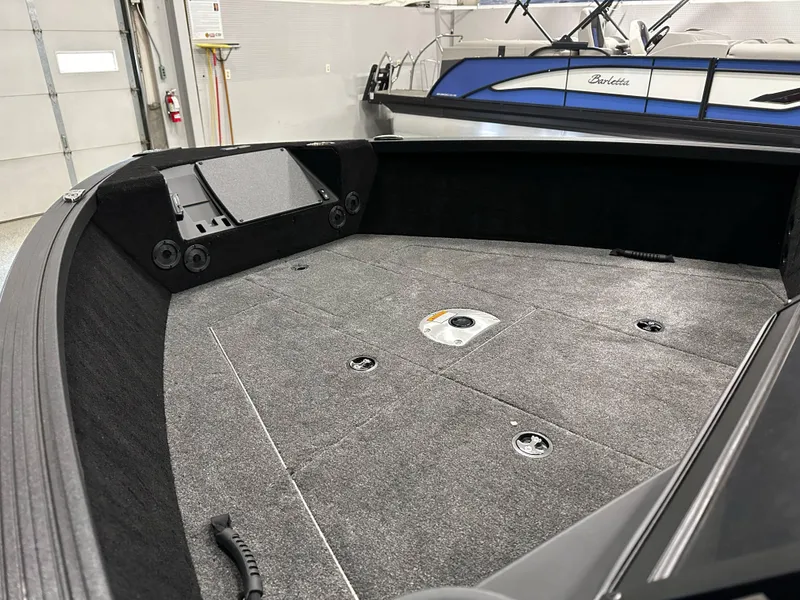 Slide: The Image of 2025 Alumacraft Competitor 185X Sport boat interior with spacious deck and storage compartments. - 12