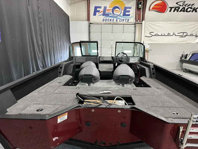 Slide: The Image of 2025 Alumacraft Competitor 185X Sport interior with two seats and storage compartments. - 14