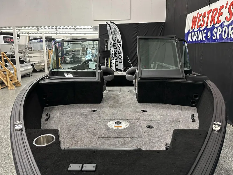 Slide: The Image of 2025 Alumacraft Competitor 185X Sport boat interior with dual seats and control panel. - 6