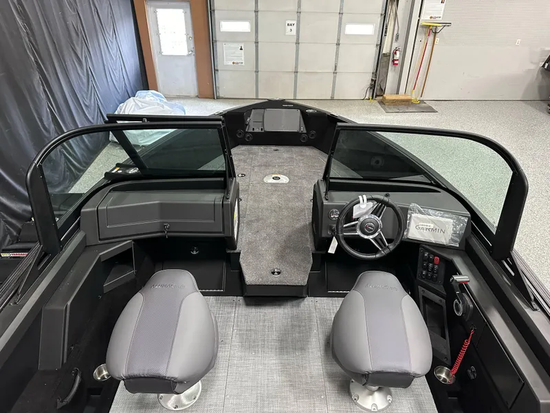 Slide: The Image of 2025 Alumacraft Competitor 185X Sport interior, featuring steering wheel and storage compartments. - 8