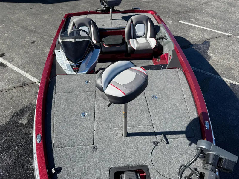 Slide: The Image of 2022 Ranger Z518 boat interior with seating and fishing deck, parked on asphalt. - 13