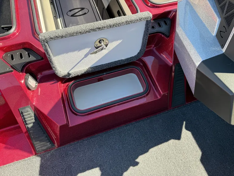 Slide: The Image of 2022 Ranger Z518 boat storage compartment with open lid, showcasing interior space. - 16