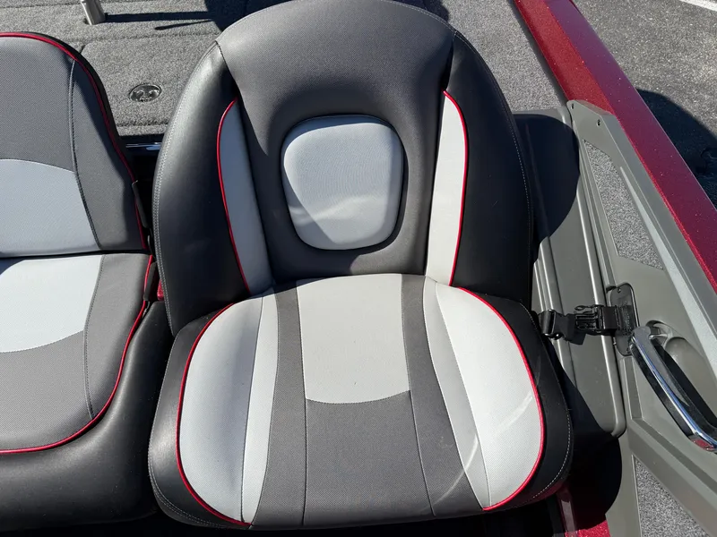 Slide: The Image of 2022 Ranger Z518 boat seat with black, gray, and white upholstery, featuring red accents. - 18