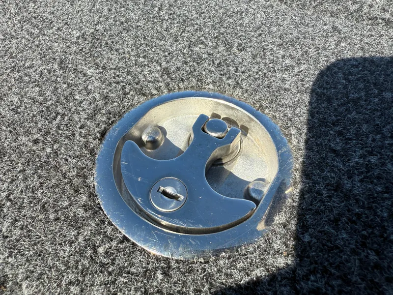 Slide: The Image of Close-up of a 2022 Ranger Z518 boat deck latch on gray carpet. - 27
