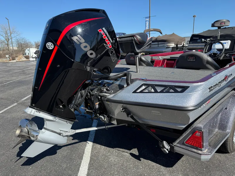 Slide: The Image of 2022 Ranger Z518 boat with powerful outboard motor in a parking lot. - 3