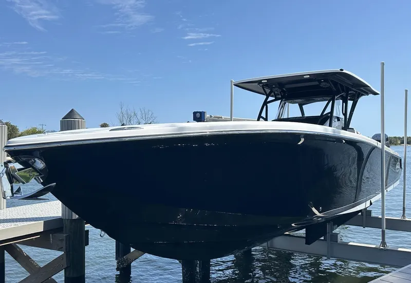 Slide: The Image of 2023 Nor-Tech 390 Sport Center Console boat docked on a sunny day. - 10