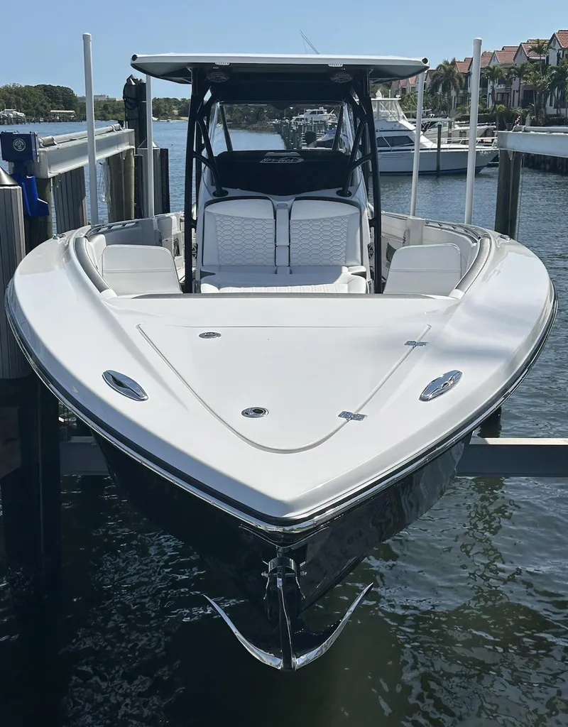 Slide: The Image of 2023 Nor-Tech 390 Sport Center Console boat docked in marina, front view. - 11