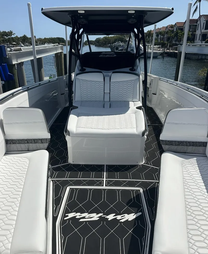 Slide: The Image of 2023 Nor-Tech 390 Sport Center Console boat with sleek seating and modern design. - 3