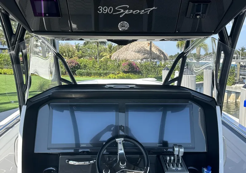 Slide: The Image of 2023 Nor-Tech 390 Sport Center Console dashboard with dual screens and steering wheel. - 6