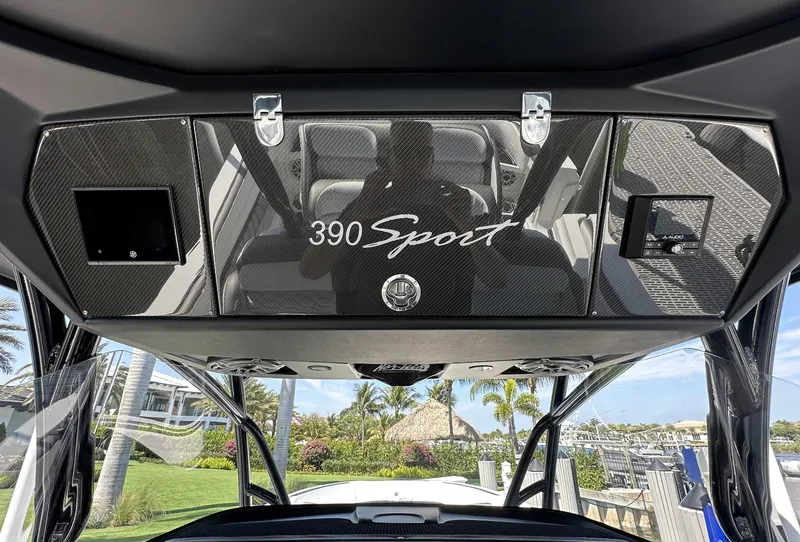 Slide: The Image of 2023 Nor-Tech 390 Sport Center Console dashboard with tropical marina view. - 7