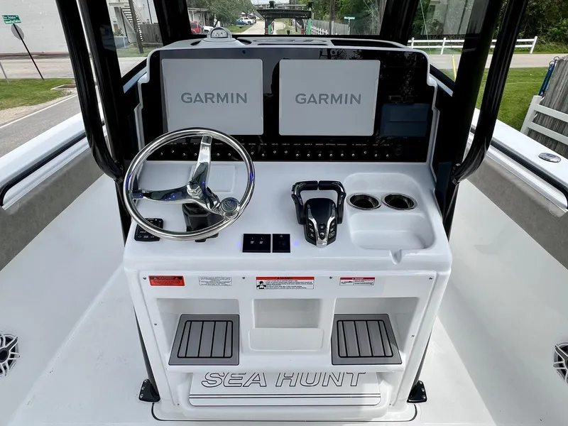 Slide: The Image of 2025 Sea Hunt Gamefish 27 helm with Garmin displays and steering wheel. - 10