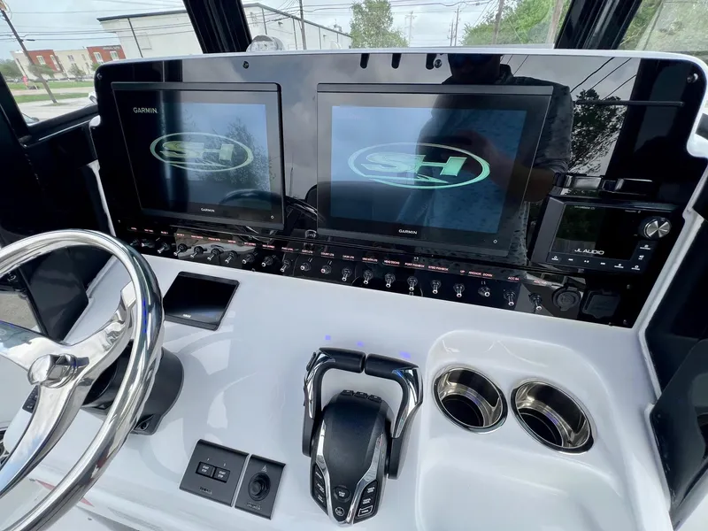 Slide: The Image of 2025 Sea Hunt Gamefish 27 dashboard with dual Garmin displays and controls. - 17