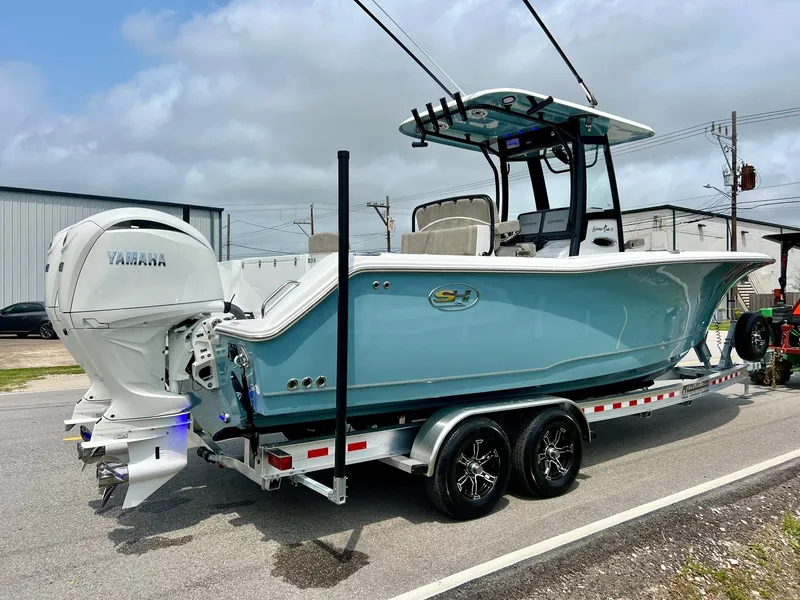 Slide: The Image of 2025 Sea Hunt Gamefish 27 with Coffin Box on trailer, featuring Yamaha outboard engines. - 4