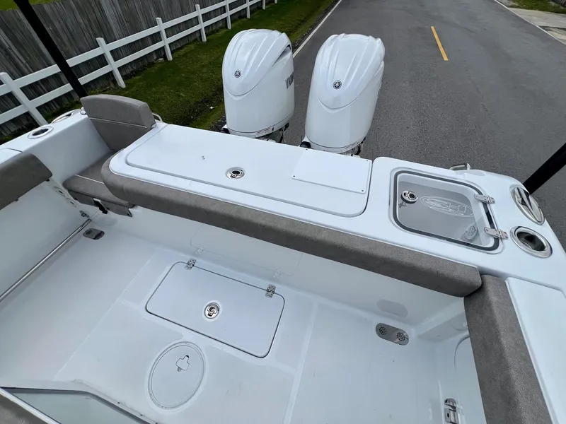 Slide: The Image of 2025 Sea Hunt Gamefish 27 boat deck with twin engines and coffin box. - 7