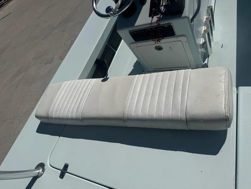 Slide: The Image of 2012 Beavertail Skiffs BT3 boat interior with white cushioned seating and steering console. - 10