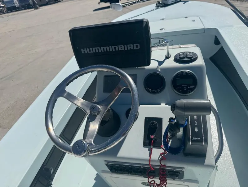 Slide: The Image of 2012 Beavertail Skiffs BT3 console with Humminbird electronics and steering wheel. - 12