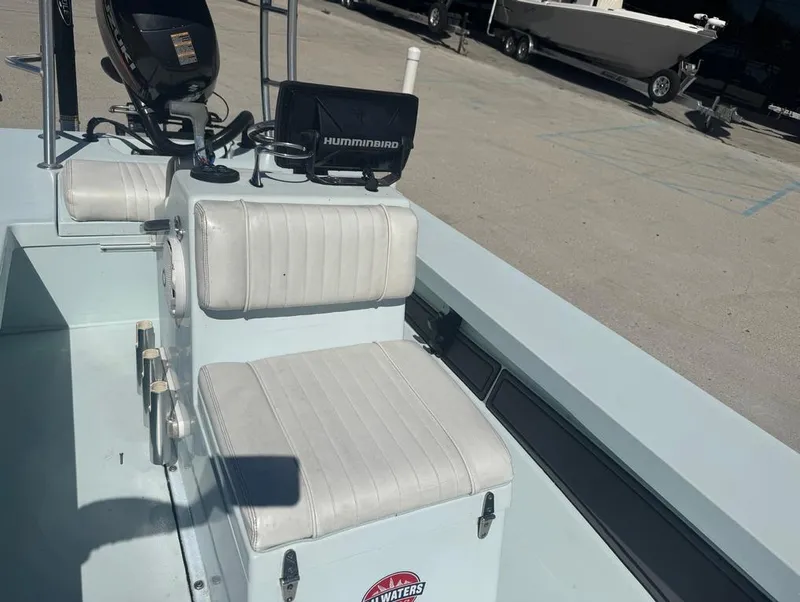 Slide: The Image of 2012 Beavertail Skiffs BT3 boat interior with white seating and Humminbird electronics. - 14