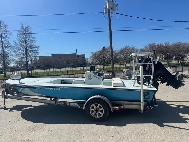 Slide: The Image of 2012 Beavertail Skiffs BT3 boat on trailer, parked outdoors under clear blue sky. - 2