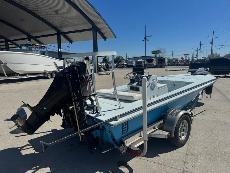 Slide: The Image of 2012 Beavertail Skiffs BT3 boat on trailer, parked outdoors under a canopy. - 6