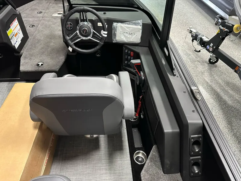 Slide: The Image of 2025 Alumacraft Competitor 185X Sport boat interior with steering wheel and seating. - 16