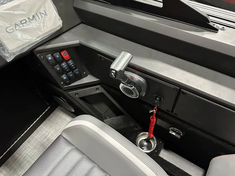 Slide: The Image of 2025 Alumacraft Competitor 185X Sport dashboard with Garmin system and control panel. - 18