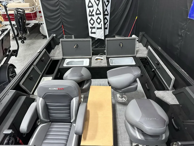 Slide: The Image of 2025 Alumacraft Competitor 185X Sport interior with gray seating and storage compartments. - 22