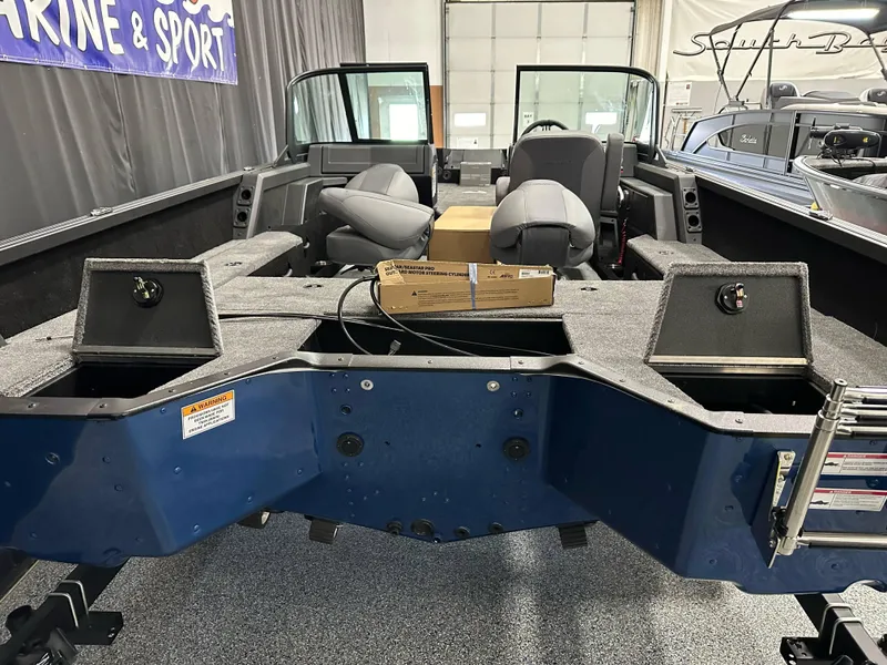 Slide: The Image of 2025 Alumacraft Competitor 185X Sport boat interior with seating and storage compartments. - 25