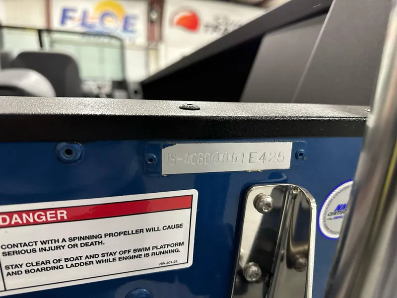 Slide: The Image of 2025 Alumacraft Competitor 185X Sport boat with safety warning label and identification plate. - 27