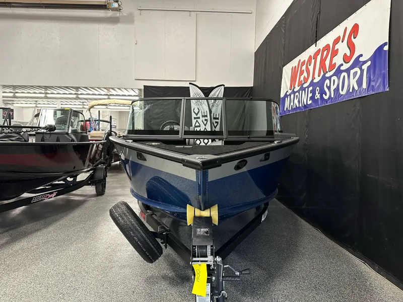 Slide: The Image of 2025 Alumacraft Competitor 185X Sport boat displayed at Westre's Marine & Sport showroom. - 5