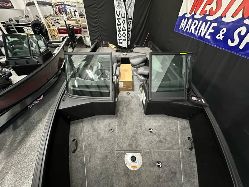 Slide: The Image of 2025 Alumacraft Competitor 185X Sport boat interior at a marine showroom. - 7