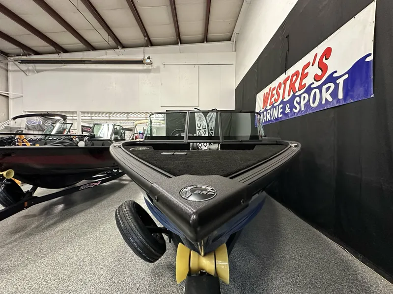 Slide: The Image of 2025 Alumacraft Competitor 185X Sport boat displayed indoors at Westre's Marine & Sport. - 8