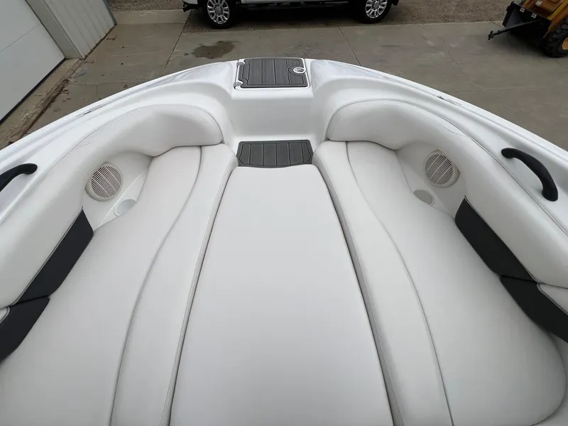 Slide: The Image of 2007 Yamaha SX210 boat interior with white cushioned seating and built-in speakers. - 10