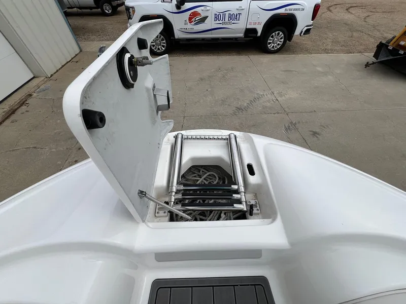 Slide: The Image of Open storage compartment on 2007 Yamaha SX210 boat, showing ladder and rope. - 12