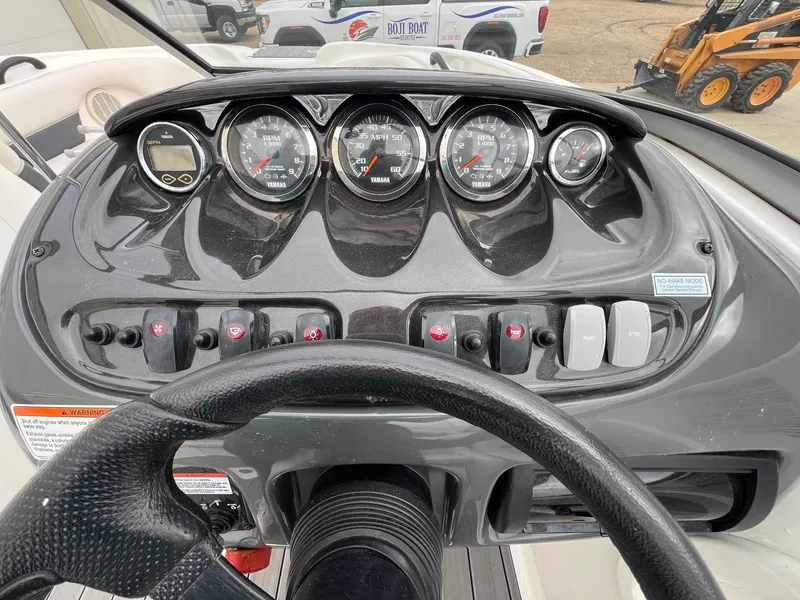 Slide: The Image of Dashboard of a 2007 Yamaha Boats SX210, featuring gauges and controls. - 15