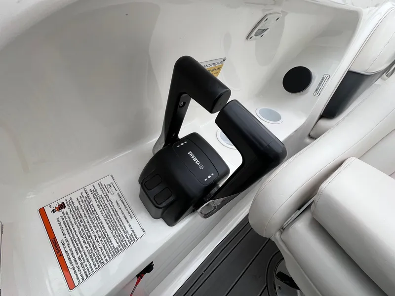 Slide: The Image of 2007 Yamaha SX210 boat throttle controls and seating area. - 17