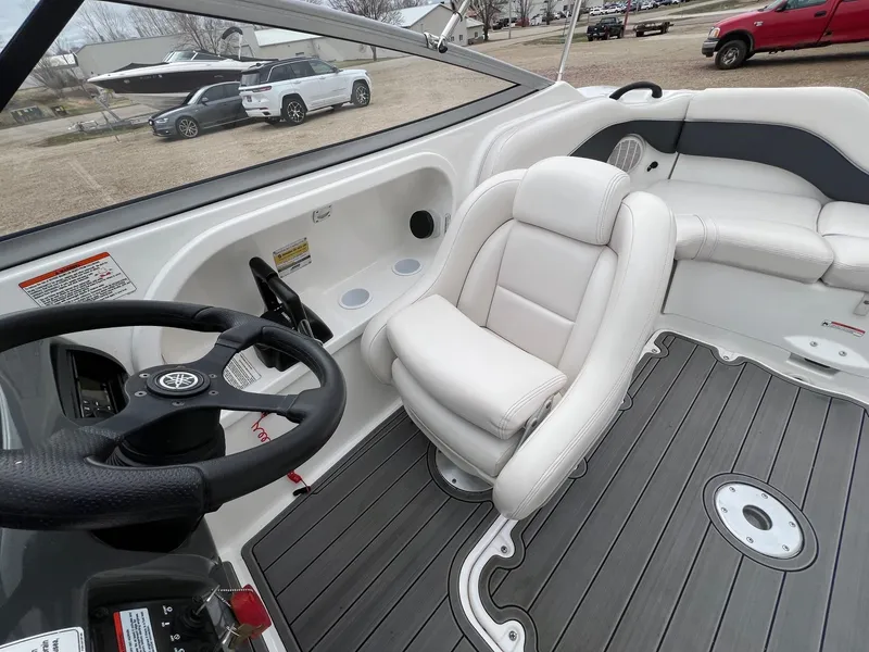 Slide: The Image of 2007 Yamaha Boats SX210 interior with steering wheel and white seating. - 18