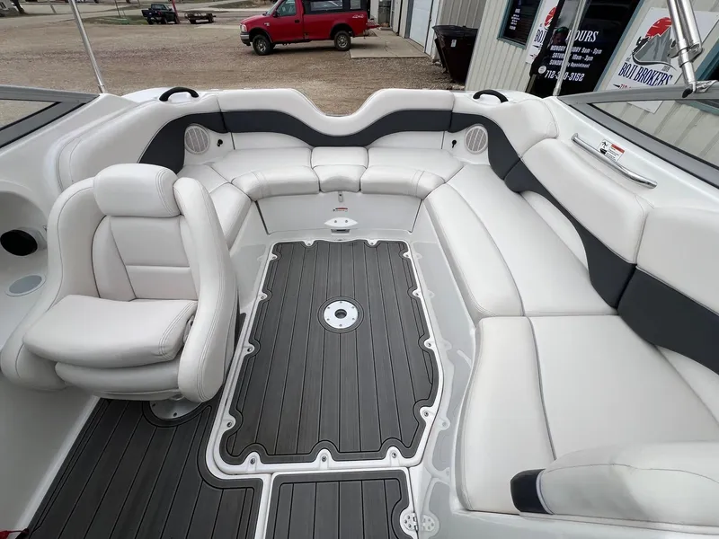Slide: The Image of 2007 Yamaha Boats SX210 interior with white seating and gray flooring. - 19