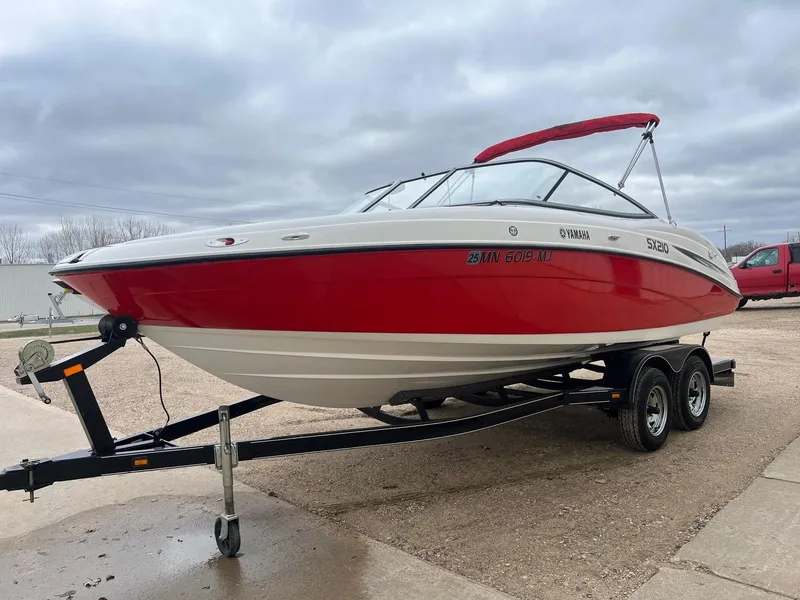 Slide: The Image of 2007 Yamaha SX210 boat on trailer, red and white design, parked outdoors. - 2