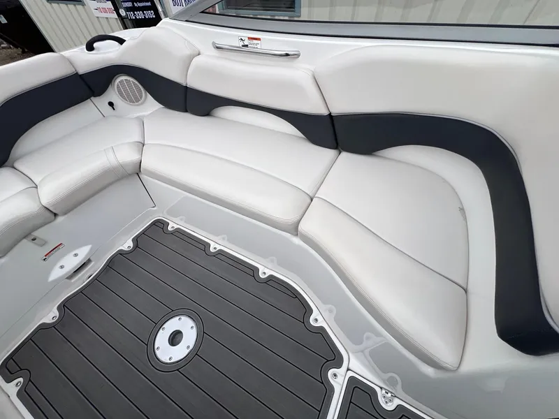 Slide: The Image of 2007 Yamaha SX210 boat interior with white and black seating and gray flooring. - 20