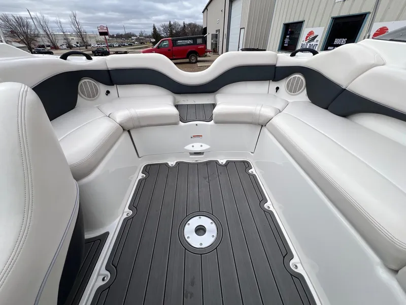 Slide: The Image of 2007 Yamaha Boats SX210 interior with white seating and gray flooring. - 21