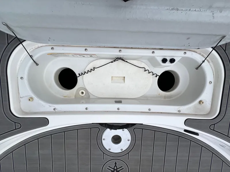 Slide: The Image of 2007 Yamaha SX210 boat storage compartment with open lid and visible interior features. - 27
