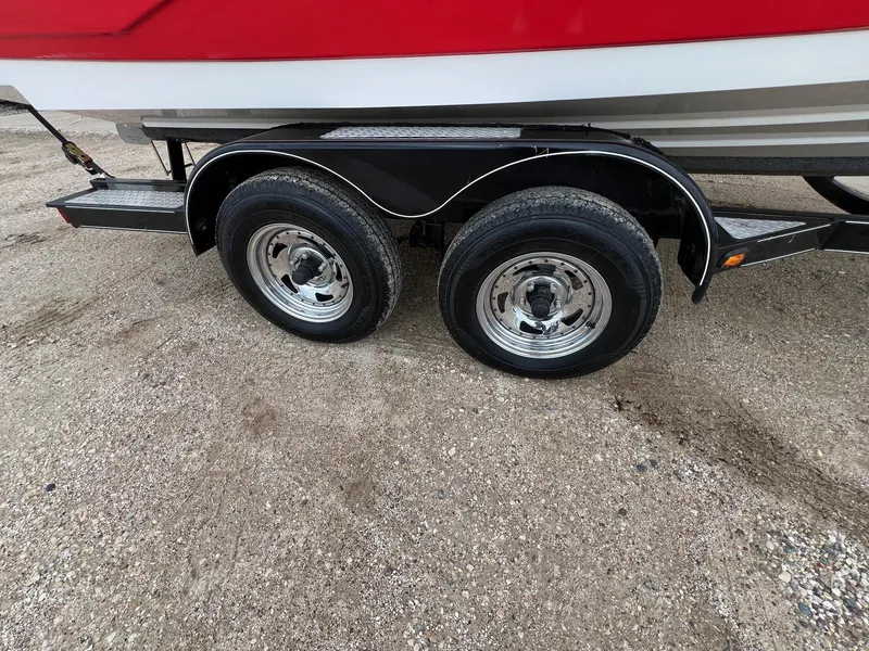 Slide: The Image of Trailer wheels of a 2007 Yamaha Boats SX210 on gravel surface. - 29