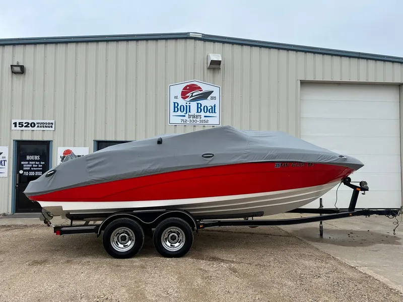 Slide: The Image of 2007 Yamaha SX210 boat with cover on trailer, parked outside Boji Boat building. - 31
